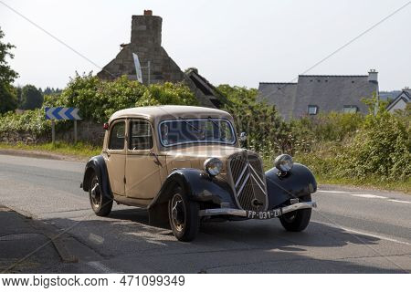 Kerlaz, France - July 17 2022: Retired Couple Cruising In A Citroën Traction Avant 7c.