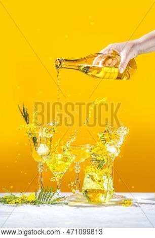 Various Elegant Martini And Whiskey Glasses With Sparkling Water, Womans Hand Pouring Water From A B