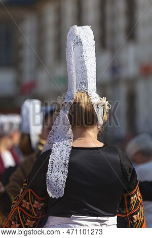 Morlaix, France - July 18 2021: Breton Dancer In Traditional Costume And Bigoudene Headdress.