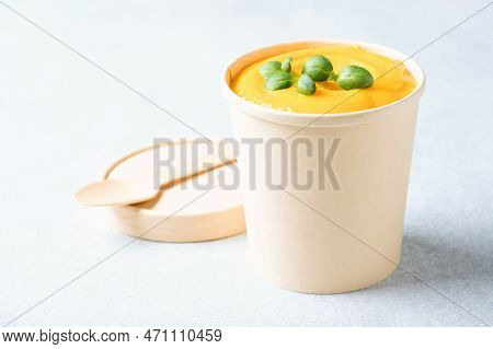Creamy Pumpkin Fall Soup In Craft Paper Food Container Against Light Gray Background. Butternut Squa