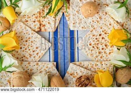Passover Celebration Concept. Blue Star Of David Made From Matzah, White And Yellow Roses, Kippah An