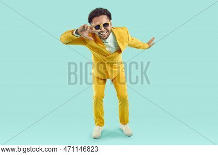 Cool Funny Man Showing V-sign And Looking At You Through It On Light Blue Background In Studio.