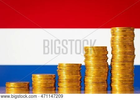 Coins Forming Upgoing Graph Near Flag Of Netherlands. Economic And Financial Growth Of Netherlands