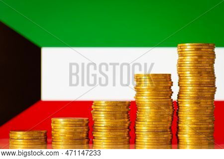 Money Coins Stacks In Rising Order In Front Of Kuwait Flag. Development Of Finance Of Kuwait Concept
