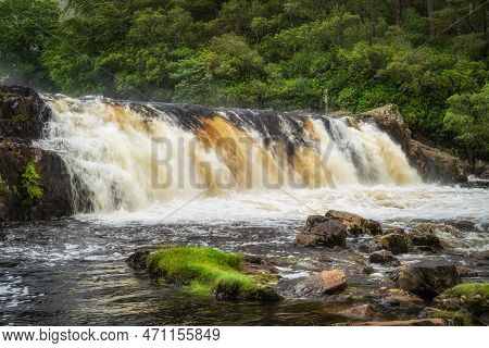 Aasleagh Falls On Erriff River With A Green, Lush Forest In Background. Waterfall On Rushing River, 