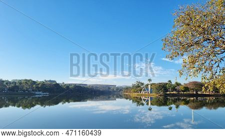 Pampulha Church Overlooking The Pampulha Lagoon, With Reflection In The Water And Blue Sky