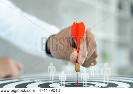 Businessman Set Goals For Work. Hand Holding A Dart Aiming At The Target Center Business. Goal, Aimi