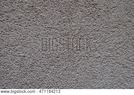 Closeup Of Dusty Wall With Coarse Light Gray Roughcast Finish