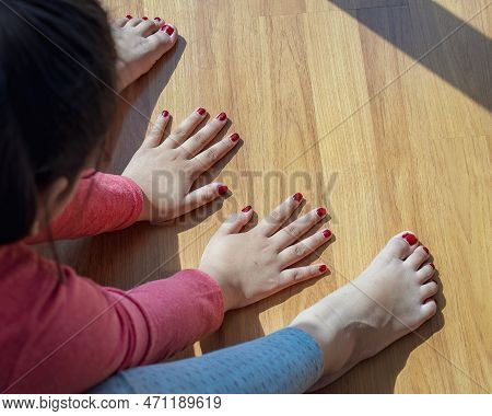 Hands And Feet With Henna In A Bright Sunlight On The Floor. Drying Henna At Home.