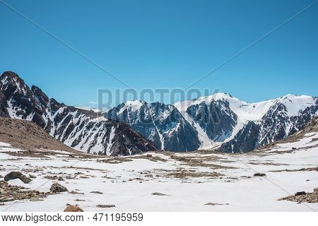 Scenic Landscape With Snowy Mountain Top. Wonderful View From Stonу Snowу Mountain To Mountain Range