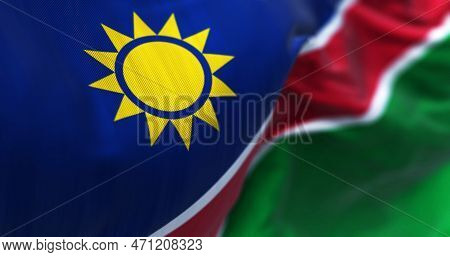 Close-up View Of The Namibia National Flag Waving. Blue Stripes, Yellow Sun, Red, White Stripes, Gre