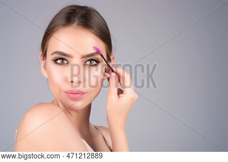Beautiful Woman With Dark Eyebrows Hold Eyebrow Brush. Eyebrows Lamination. Brow Beauty Procedures. 