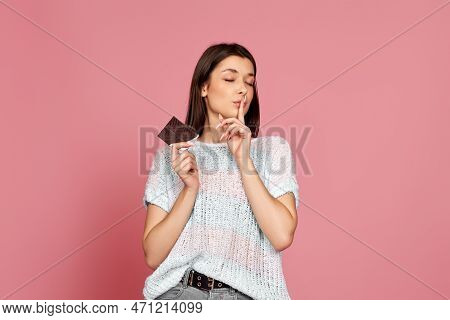 Young Woman In Sweater Holding Chocolate Bar
