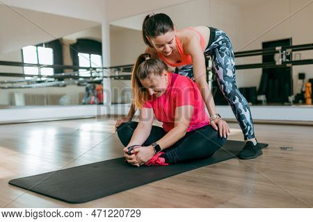 Fitness Trainer And Mentee Over Gym Room Background. Sport And Healthy Active Lifestyle Concept. Ind