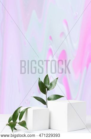 Cosmetic Gradient Background With Geometric Shapes And A Ruskus Branch. Two Cubic Podiums In White A