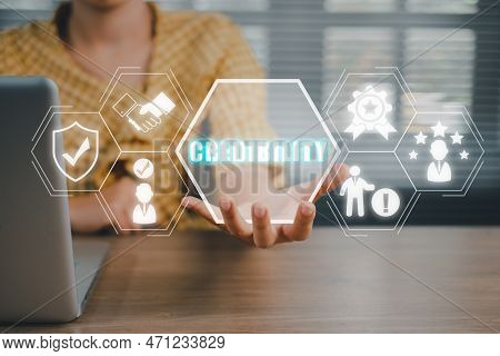Corporate Credibility Improvement Concept, Business Person Hand Holding Credibility Icon On Virtual 