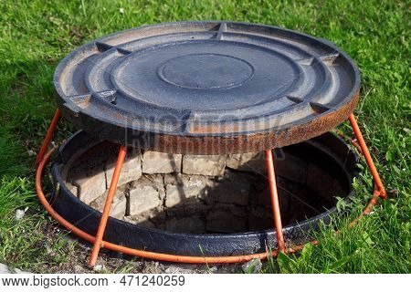 Open Well Hatch On Green Lawn. Manhole Cover Is On Stand. Device For Ventilation Of Wells..