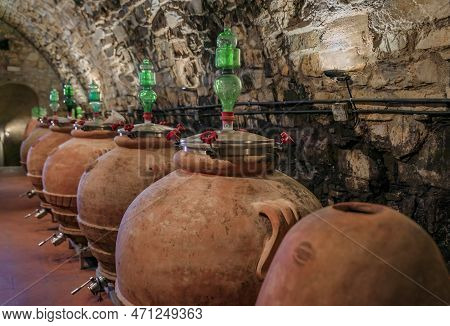 Chianti Wine From Sangiovese Grapes Aging In Terracotta Clay Amphora At A Vineyard Cellar In The Fam
