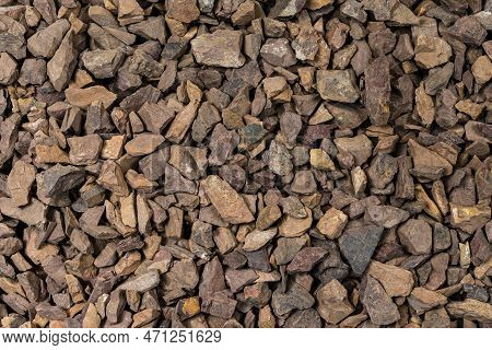 Close-up Image Of Background Made Of Pile Of Colorful Brown, Yellow And Red Crushed Stones.