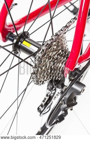 Road Cycling Ideas. Rear View Closeup Of Rear Derailier And Rear Cassette With New Chain Against Whi