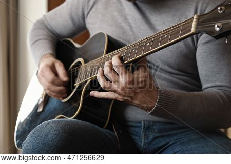 Playing The Guitar. Strumming Black Acoustic Guitar. Musician Plays Music. Man Fingers Holding Media
