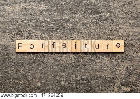 Forfeiture Word Written On Wood Block. Forfeiture Text On Table, Concept.