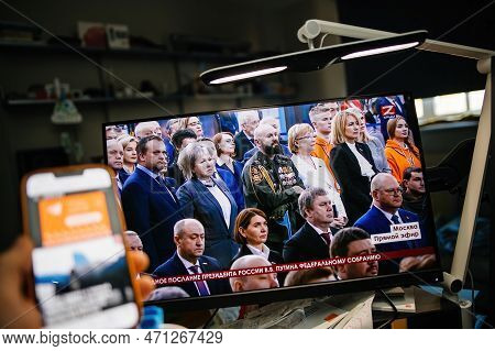 Paris, France - Feb 21, 2023: Man Reading News On Smartphone Watching On Pc Krym 24 Station Direct S