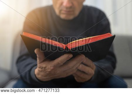Man Praying And Reading Bible At Home.