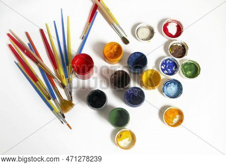 Watercolor Paints Next To The Brushes. For Artists, There Are A Lot Of Colored Paints And Brushes. P