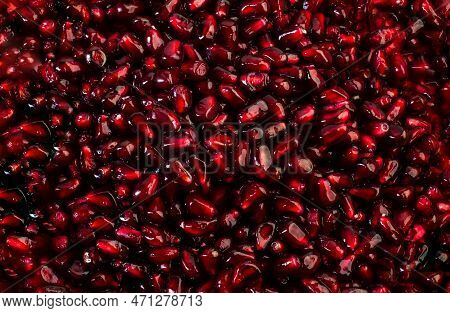 Delicious Mature Red Ripe Juicy Pomegranate Seeds Background Texture Pattern.