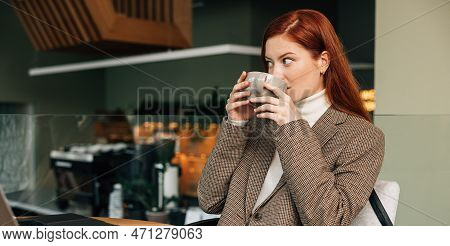 Woman In Blazer Drinking Coffee At Coffee Shop
