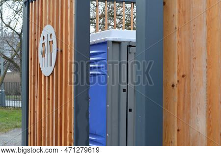 Closing Cage For Placing Chemical Toilets. Unsightly Plastic Boxes Are Inside Metal House With Flat 