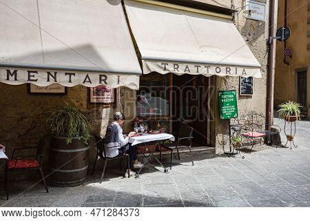 Tuscany, Arezzo – May, 2022: Cityscape. Small Street Cafe 