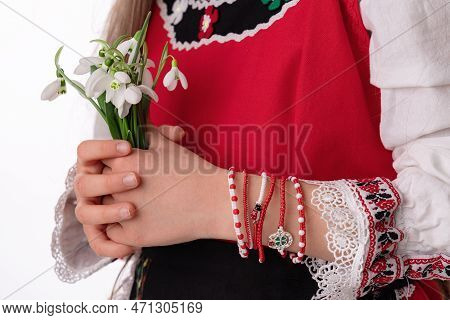 Bulgarian Girl In Traditional Folklore Costumes With Spring Flowers Snowdrop And Handcraft Wool Brac