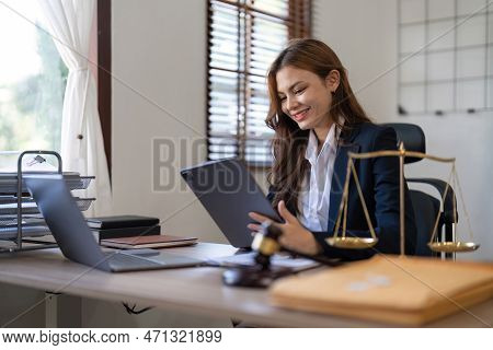 Attractive Young Lawyer In Office Business Woman And Lawyers Discussing Contract Papers With Brass S