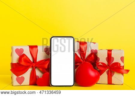 Mobile Phone With Blank Screen On Colored Background With Hearts, Calendar And Gift Box, Valentine D