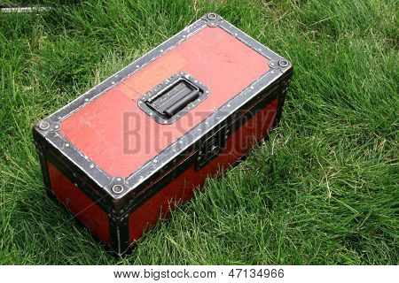 Red Tin Box On A Green Lawn