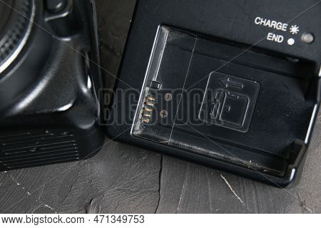 Ukraine, Chernihiv, February 21, 2023: Old Used Photo Equipment, Old Nikon Camera And Charger On A G