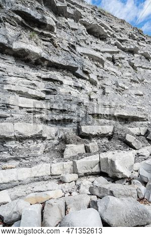 Cliffs In East Cliff Beach In Lyme Regis, Dorset, South West England. Close Up Of Stacked Under Time