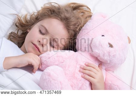 Little Boy Sleeps. Cute Child Sleeping With A Toy Teddy Bear On Bed At Home. Bedtime, Kid Sleeps. Ki