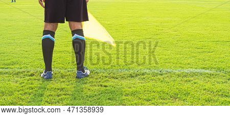 Low Section Of Soccer Assistant Referee (linesman) Standing On The Edge Of Field, Panoramic View Wit