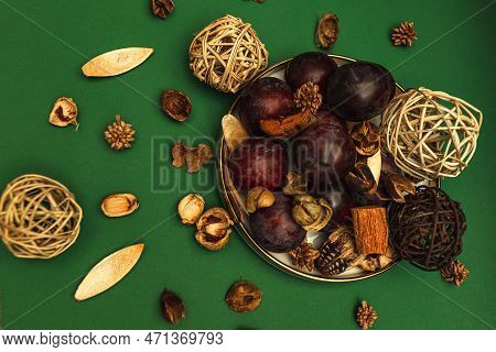 Uicy Plums On A Gold-rimmed Platter. On A Green Background.