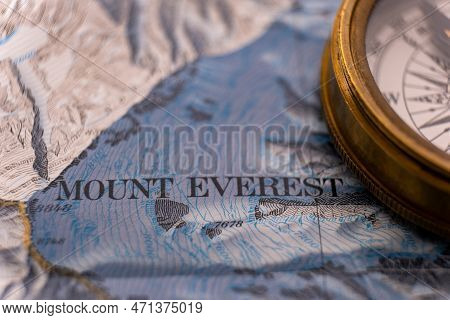 Close Up Of Vintage Compass On Map Detail Of Mt. Everest Topographical Map Showing Contour Lines, El