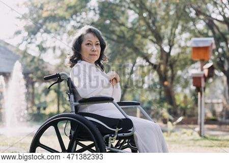 Asian Young Caregiver Nurse Support Senior Older Male Walking Outdoors. Specialist Girl Doctor Help