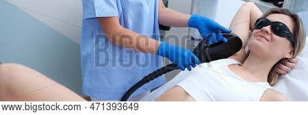 Young Woman Undergoes Armpit Laser Hair Removal Treatment At Beauty Spa. Hair Removal In Hone Armpit