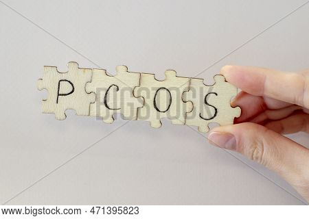 Polycystic Ovarian Syndrome. Hand Writing Pcos On Wooden Puzzles.