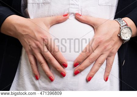 Close-up Of Adult Female Entrepreneur Wearing Casual Suit And Shirt Touching Abdomen As Painful Stom