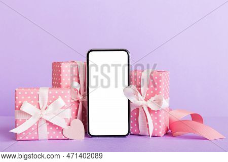 Mobile Phone With Blank Screen On Colored Background With Hearts, Calendar And Gift Box, Valentine D