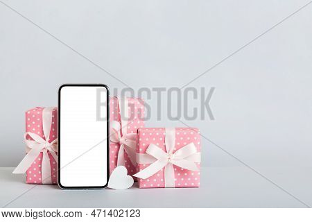 Mobile Phone With Blank Screen On Colored Background With Hearts, Calendar And Gift Box, Valentine D