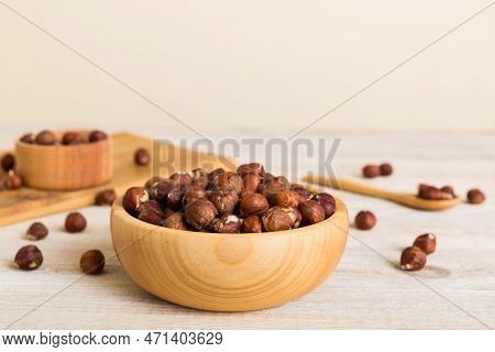 Wooden Bowl Full Of Hazelnuts On Table Background. Healthy Eating Concept. Super Foods.